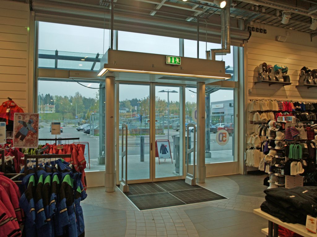 En sidoblåsande luftridå från RMK i en entré med sportkläder.