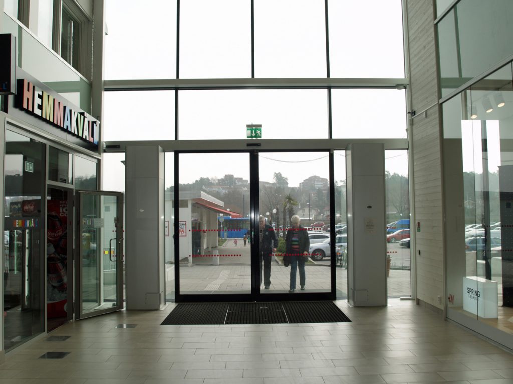 Sidoblåsande luftridåer från RMK i en entré med höga fönster.